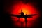 German Junker (Ju-87) jet-propelled model plane in possession. Dark orange fire background. War scene. Selective focus (Difference