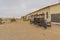 German Kolmanskop Ghost Town with the abandoned buildings in the Namib desert with a wagon from a train