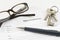 German lease agreement document with house keys, glasses and a