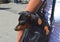 German miniature pinscher pet dog sitting in its owner`s handbag on a busy city street