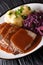 German national dish Sauerbraten served with knodel potato dumplings and red cabbage close-up. vertical