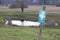 German nature conservation area shield in front of a moor landscape with a small lake in the background, german text translation: