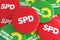 German Politics Concept: Pile of Buttons With The Logo of The Political Parties SPD And The Greens, 3d illustration