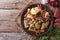 German potato salad on a plate and ingredients top view horizontal