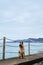 German shepherd on the beach. Shepherd dog sits on the pier against the blue sea and poses beautifully