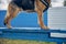 German Shepherd dog standing on blue wooden bench