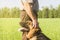 German shepherd stroking his master`s hand outdoors in a field.