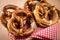 German soft Brezel pretzel with salt, chives and butter in bread basket