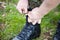 German soldier laces his boots on grass