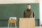 German soldier stands in a classroom