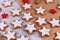 German star shaped glazed Christmas cookies called `Zimtsterne` made with amonds, egg white, sugar, cinnamon