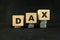 German stock market, Germany economy growth and recovery concept. DAX index in wooden blocks with increasing stack of coins