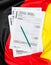 German tax form on the german flag. Top view. Translation:income tax return, capital income, Application employee`s savings, los