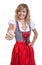 German woman in a traditional bavarian dirndl showing thumb up