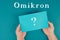 The german word for omicron is standing on a paper, new covid-19 variant from south africa