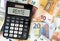German word RENTE pension on display of pocket calculator against paper money
