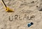 German writing Urlaub in the sand