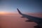 Germany - 15/06/2019: wing of airplane Wizzair company at sunset. Pink evening sky with Wizz air plane. Aviation and travel.