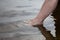 Germany, Baltic Sea, woman, feet in the water