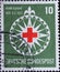 GERMANY - CIRCA 1953:On this postal stamp printed in Germany, you can see the symbol of the Red Cross in a stylized wind rose. The