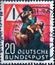 GERMANY - CIRCA 1953: Preventing traffic accidents is the motto of this postal stamp. You can see a mother holding her child in he