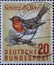 GERMANY - CIRCA 1957: This postage stamp shows a robin sitting on a path. Text: Protects the animals