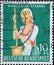 GERMANY - CIRCA 1958: a charitably  postage stamp printed in Germany showing a farmer with traditional costume, apron and headscar