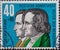 GERMANY - CIRCA 1959: a postage stamp printed in Germany showing a Portrait of the Brothers Grimm against a blue background