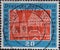 GERMANY - CIRCA 1959: a postage stamp printed in Germany is showing  the silhouette of Buxtehude Germany in white on a red backgro