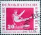 GERMANY, DDR - CIRCA 1959 : a postage stamp from Germany, GDR showing a man in a gymnast`s dress doing gymnastics on the pommel h