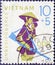 GERMANY, DDR - CIRCA 1968: a postage stamp from Germany, GDR showing a Vietnamese with child, hat and rifle. Text: Invincible Viet