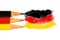 Germany flag colours in coloured pencils in black, red and gold in a closeup photo isolated on white background with space text