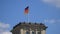 Germany Flag Fluttering Upon The Reichstag Building in Berlin, Germany