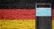 Germany flag painted on brick wall and closed door with medical mask protected