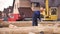 Germany - Hamburg, 08.23.2019: construction worker picking up on the hook the rope to lift the wooden beam, framework