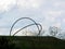 Germany, Herten, May 16, 2021, 349 p.m., in the blurred foreground branches of bushes, behind them the hill of the dump