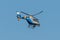 Germany Koblenz 05.04.2020 D-HRPB police helicopter flies over the city in blue sky background searching for suspect