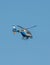 Germany Koblenz 05.04.2020 D-HRPB police helicopter flies over the city in blue sky background searching for suspect
