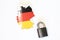 Germany national flag with outline on a white background with a closed lock top view. The concept of closing the borders of the