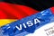 Germany Visa in passport. USA immigration Visa for Germany citizens focusing on word VISA. Travel Germany visa in national