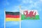 Germany and Wales two flags on flagpoles and blue cloudy sky