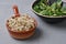 Germinated microgreens for healthy nutrition, flax and sunflower sprouts in bowls on a gray background, vegetarian food