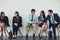 Get connected to business minded people. Studio shot of a group of businesspeople using wireless technology while