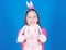 Get in easter spirit. Happy childhood. Bunny ears accessory. Lovely playful bunny child hugs soft toy. Bunny girl with