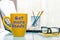 Get more leads motivation phrase on yellow cup of morning coffee or tea at business office workplace backgound. With