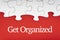 GET ORGANIZED  text with jigsaw puzzle on red background.