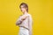 Get out! Portrait of angry young bossy woman with fair hair in casual beige blouse, isolated on yellow background