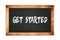 GET  STARTED text written on wooden frame school blackboard