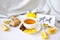 GET WELL - written on piece of paper among the products for the treatment of common cold - lemon, ginger, chamomile tea. Vitamin