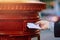 Get your message across the old fashion way. Cropped shot of a man posting mail into a postbox in the city.